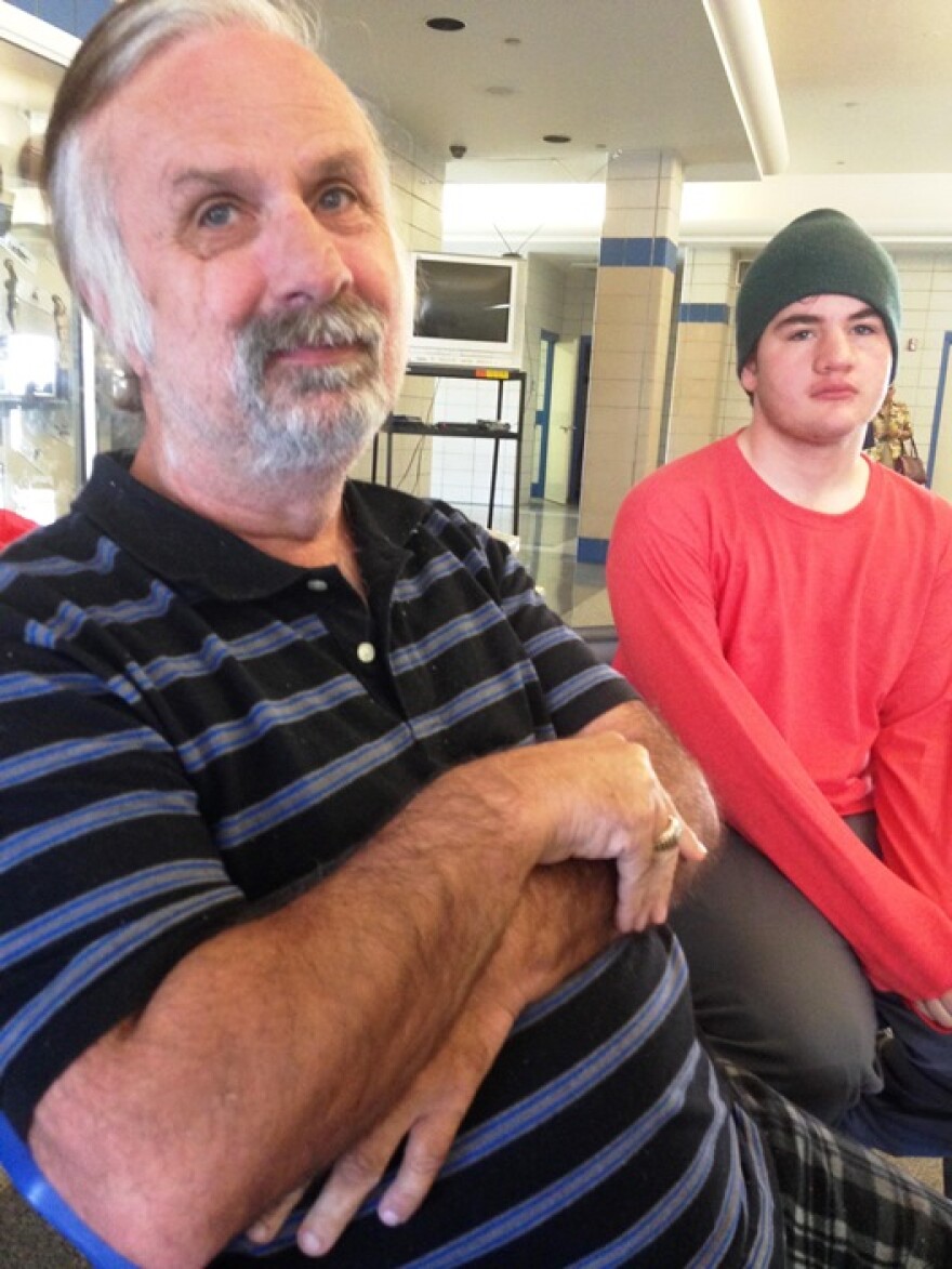 Jack Hutchinson (left) and son Matthew Hutchinson, 17, stay at the Red Cross shelter at Southern University at Shreveport as they await information on their flooded home.